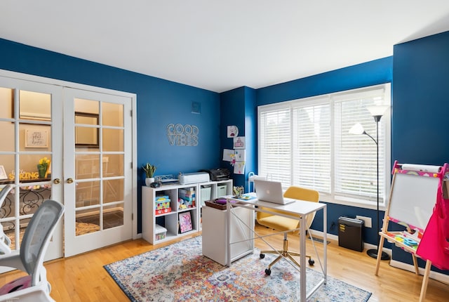 office space with french doors and wood finished floors