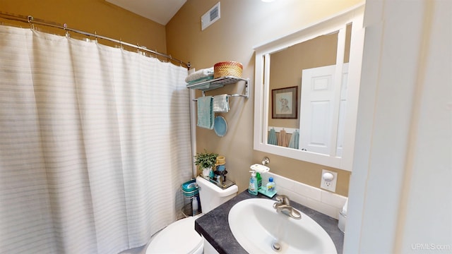 bathroom featuring curtained shower, visible vents, toilet, and vanity