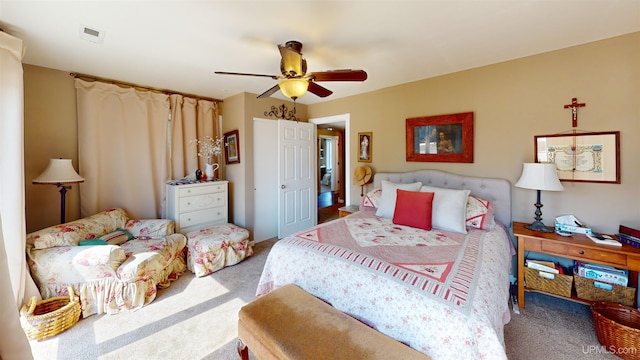 bedroom with carpet, visible vents, and ceiling fan
