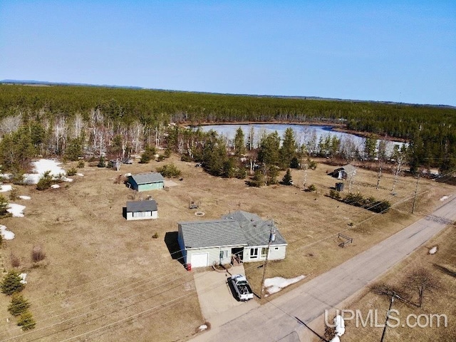 bird's eye view with a wooded view and a water view