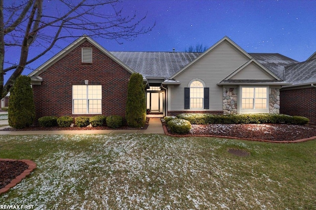ranch-style home with brick siding and a shingled roof