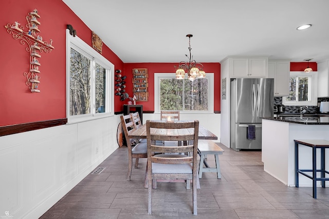 dining area with a chandelier, visible vents, and recessed lighting