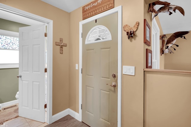 tiled entrance foyer featuring baseboards