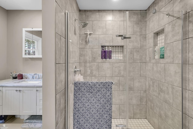 bathroom with a shower stall and vanity