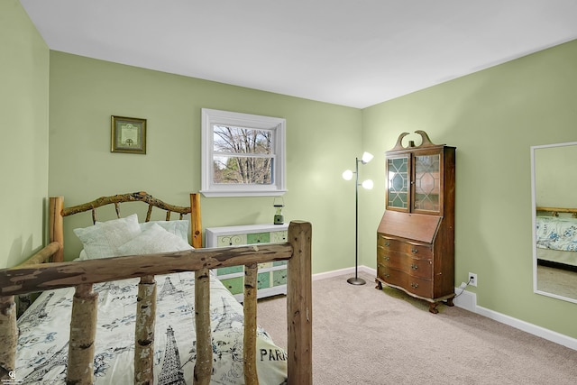 carpeted bedroom featuring baseboards