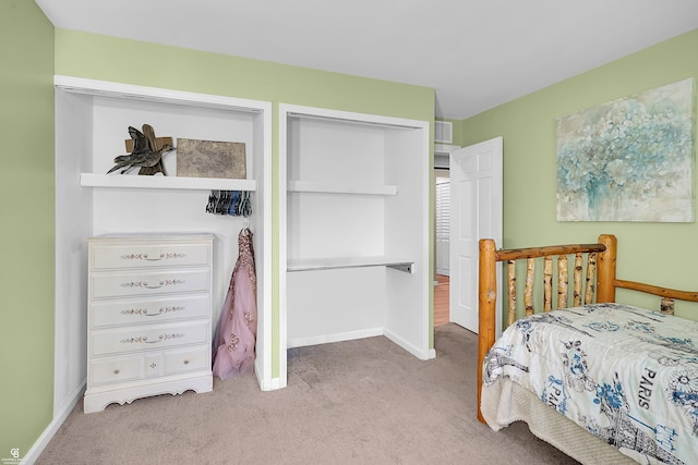 carpeted bedroom featuring visible vents and baseboards
