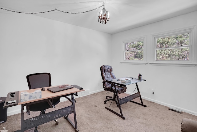 office space featuring light colored carpet, baseboards, a notable chandelier, and visible vents