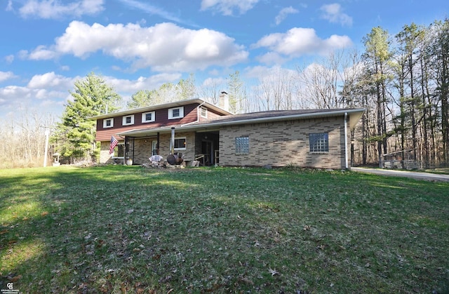 view of front of house with a chimney and a front yard