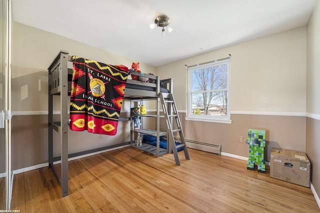 bedroom featuring baseboards and wood finished floors