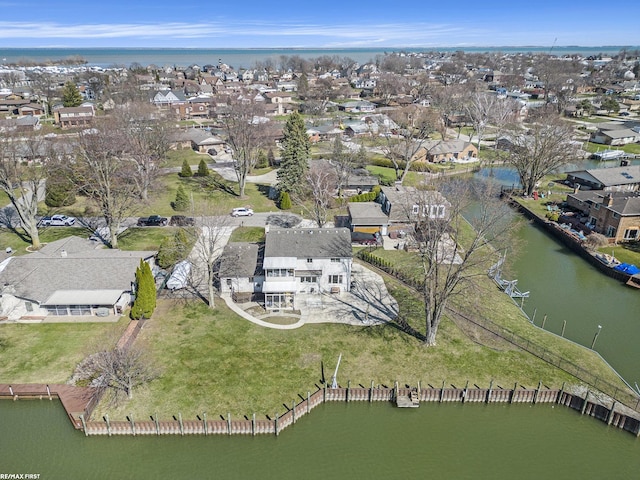 drone / aerial view featuring a water view and a residential view