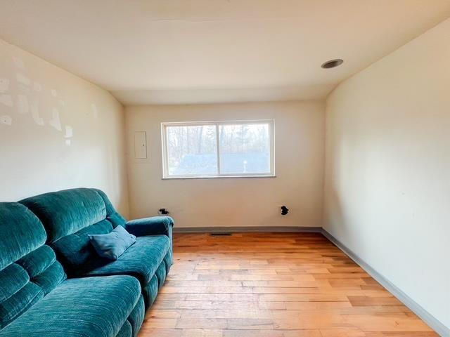 sitting room featuring baseboards and light wood-type flooring