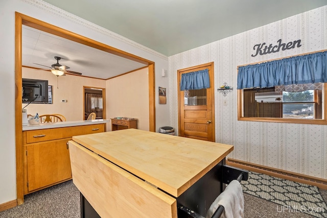 interior space with wallpapered walls and ceiling fan