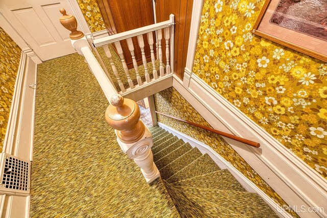 stairway with wallpapered walls
