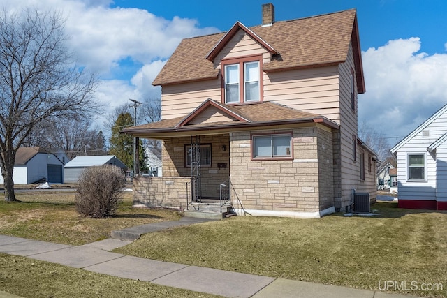 view of front of property with a porch, a shingled roof, a front yard, and central AC