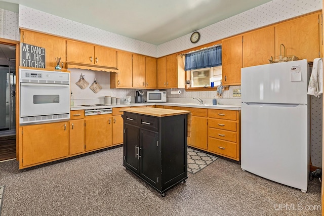 kitchen with wallpapered walls, white appliances, and tile patterned floors
