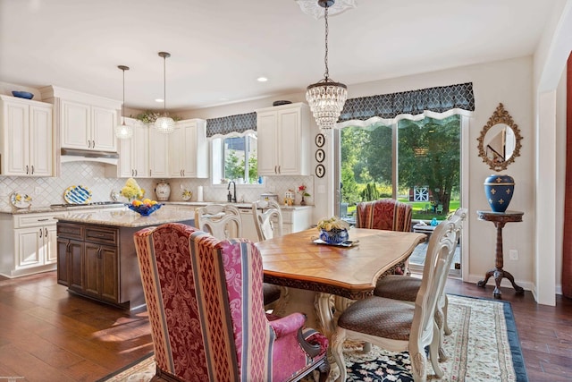 dining area featuring baseboards, dark wood-style flooring, a chandelier, and recessed lighting