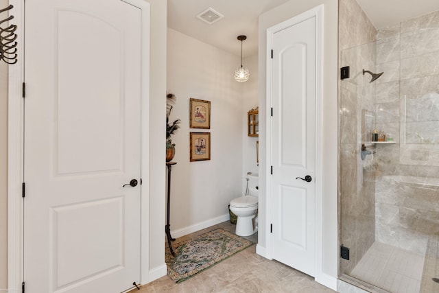 bathroom featuring baseboards, visible vents, toilet, and a stall shower