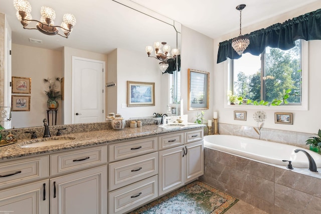 bathroom with a bath, visible vents, a sink, and a notable chandelier