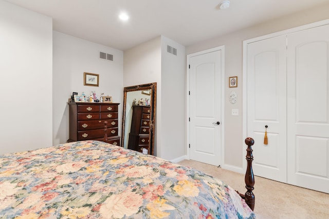 carpeted bedroom featuring a closet, visible vents, and recessed lighting