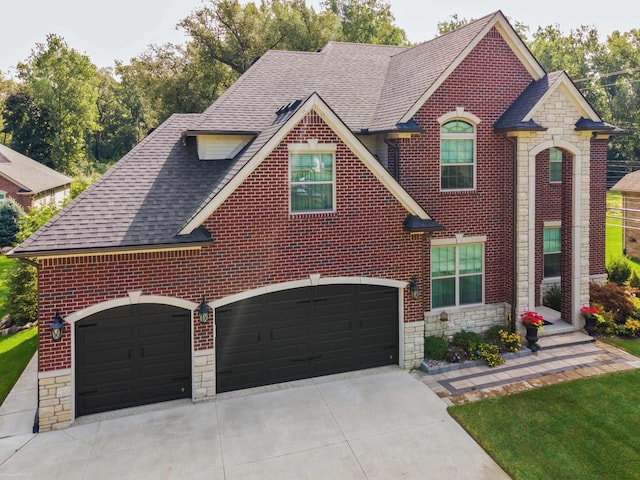 view of front of house with stone siding, driveway, and brick siding