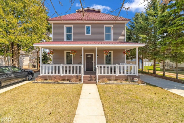 view of front of house with a front lawn, a porch, and metal roof