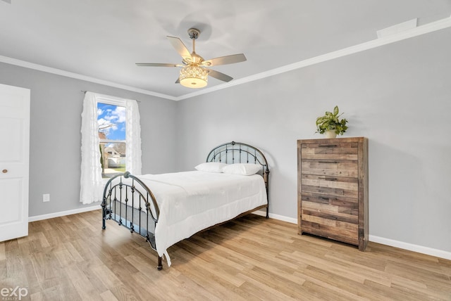 bedroom featuring a ceiling fan, baseboards, ornamental molding, and wood finished floors
