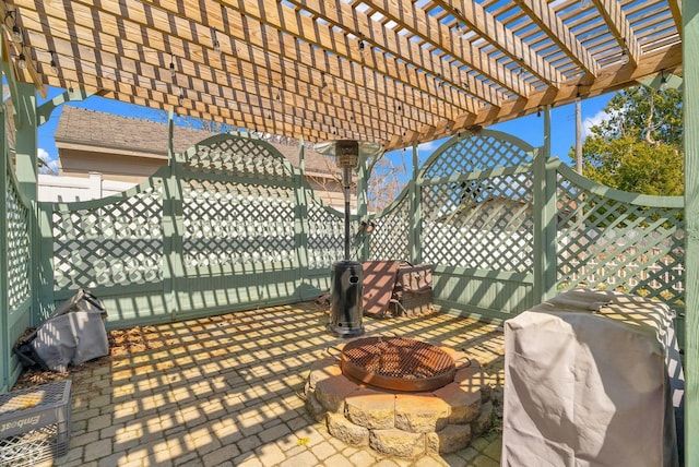 view of patio / terrace with a fenced backyard, a pergola, an outdoor fire pit, and area for grilling
