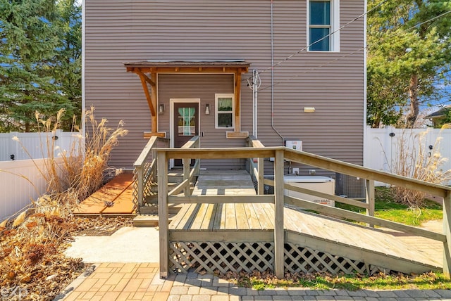 exterior space featuring fence and a deck
