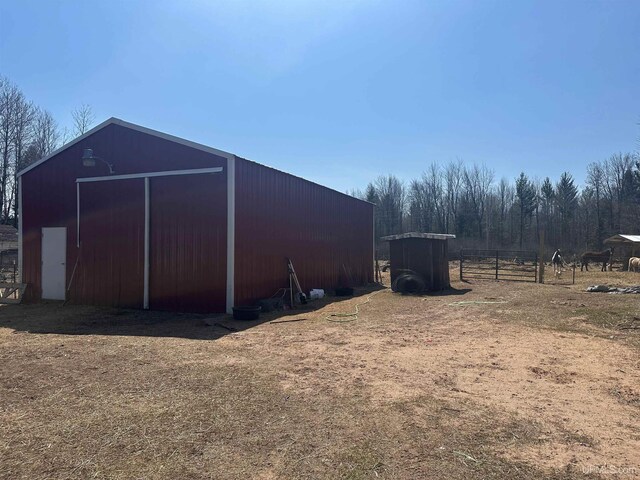 view of pole building with fence