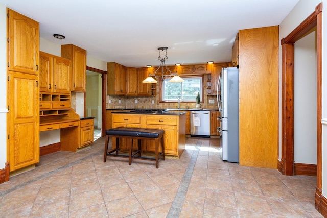 kitchen featuring stainless steel appliances, dark countertops, decorative backsplash, brown cabinetry, and a kitchen island