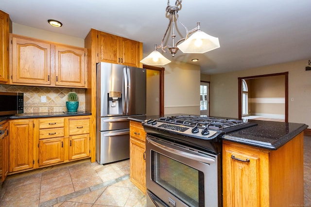kitchen featuring stainless steel appliances, a center island, dark stone counters, tasteful backsplash, and pendant lighting