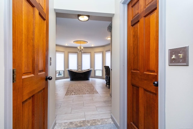 entryway featuring light tile patterned flooring, baseboards, and ornamental molding