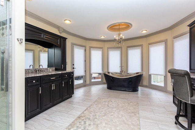 bathroom with a freestanding bath, crown molding, vanity, and a chandelier