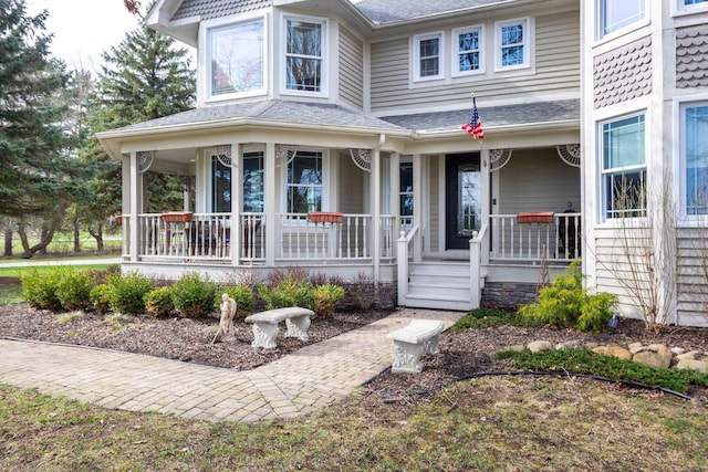 view of exterior entry with a porch