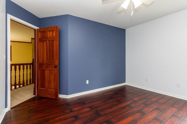 unfurnished room with baseboards, a ceiling fan, and wood finished floors