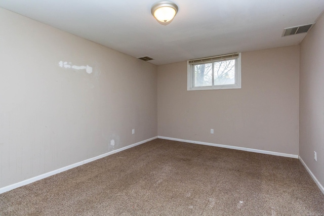 spare room with visible vents, carpet flooring, and baseboards