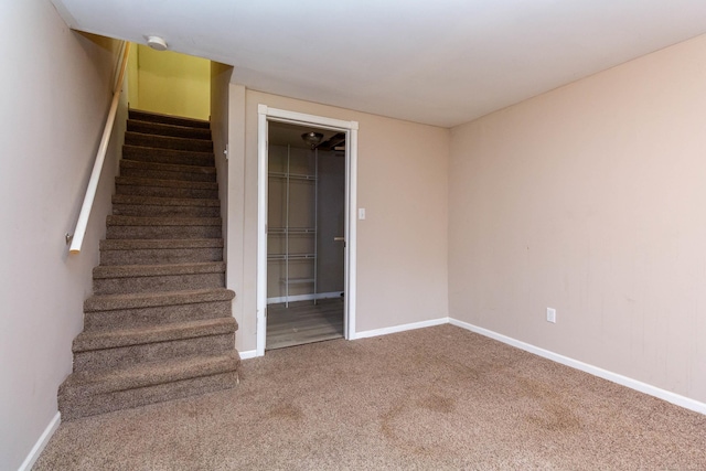 stairs featuring carpet flooring and baseboards