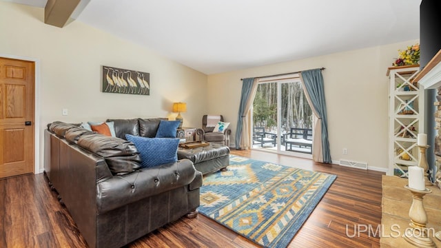 living area featuring lofted ceiling with beams, baseboards, dark wood-style floors, and visible vents