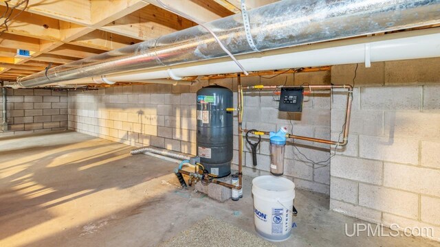 unfinished basement with concrete block wall