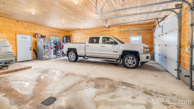 garage featuring wooden walls and wood ceiling