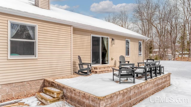 snow covered patio with entry steps