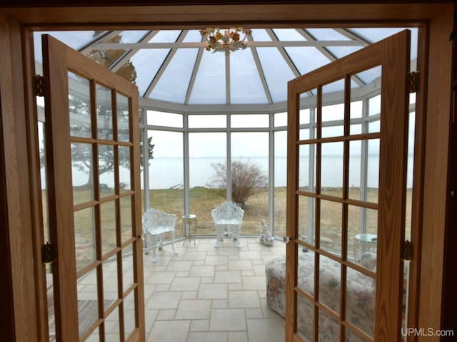unfurnished sunroom featuring stone finish flooring