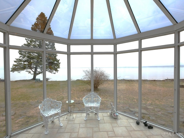 unfurnished sunroom with a water view