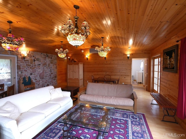 living area with light wood finished floors, vaulted ceiling, a notable chandelier, wood walls, and wood ceiling