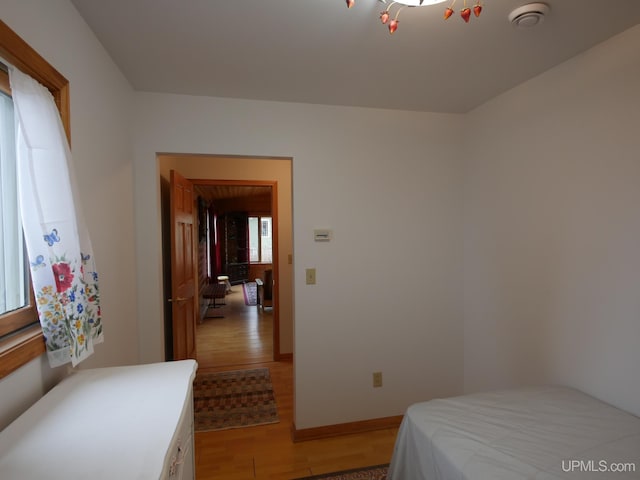 bedroom with baseboards and light wood-style floors