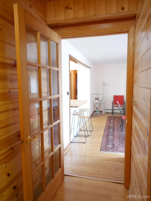 hall with wood finished floors and french doors