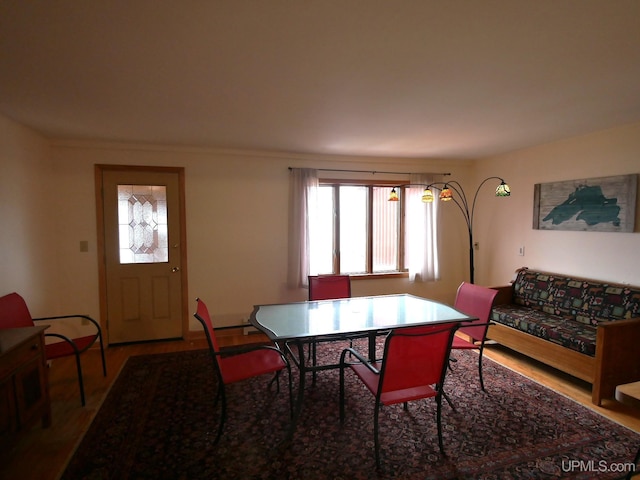 dining space with wood finished floors