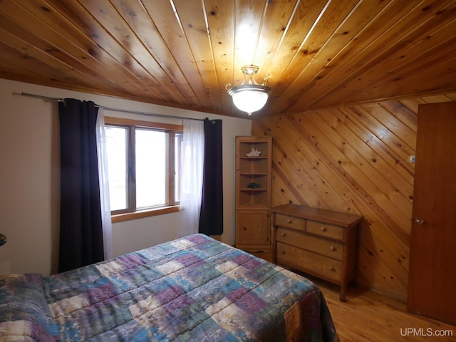 bedroom featuring light wood-style flooring and wooden ceiling