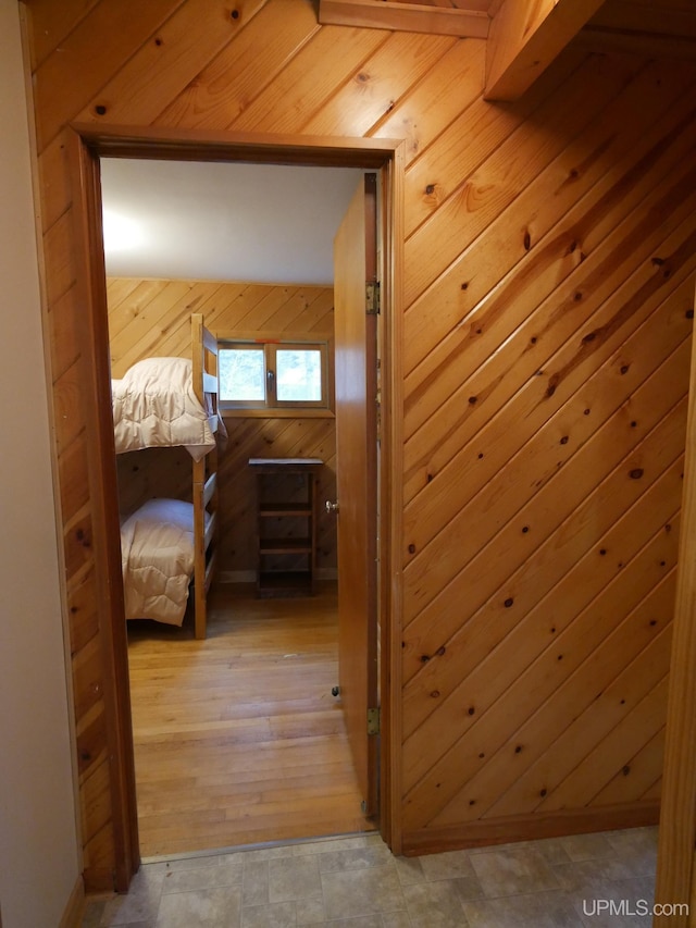 hallway with wooden walls and baseboards