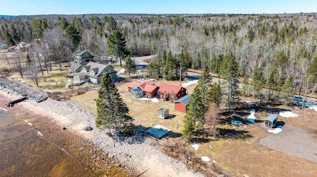drone / aerial view featuring a wooded view